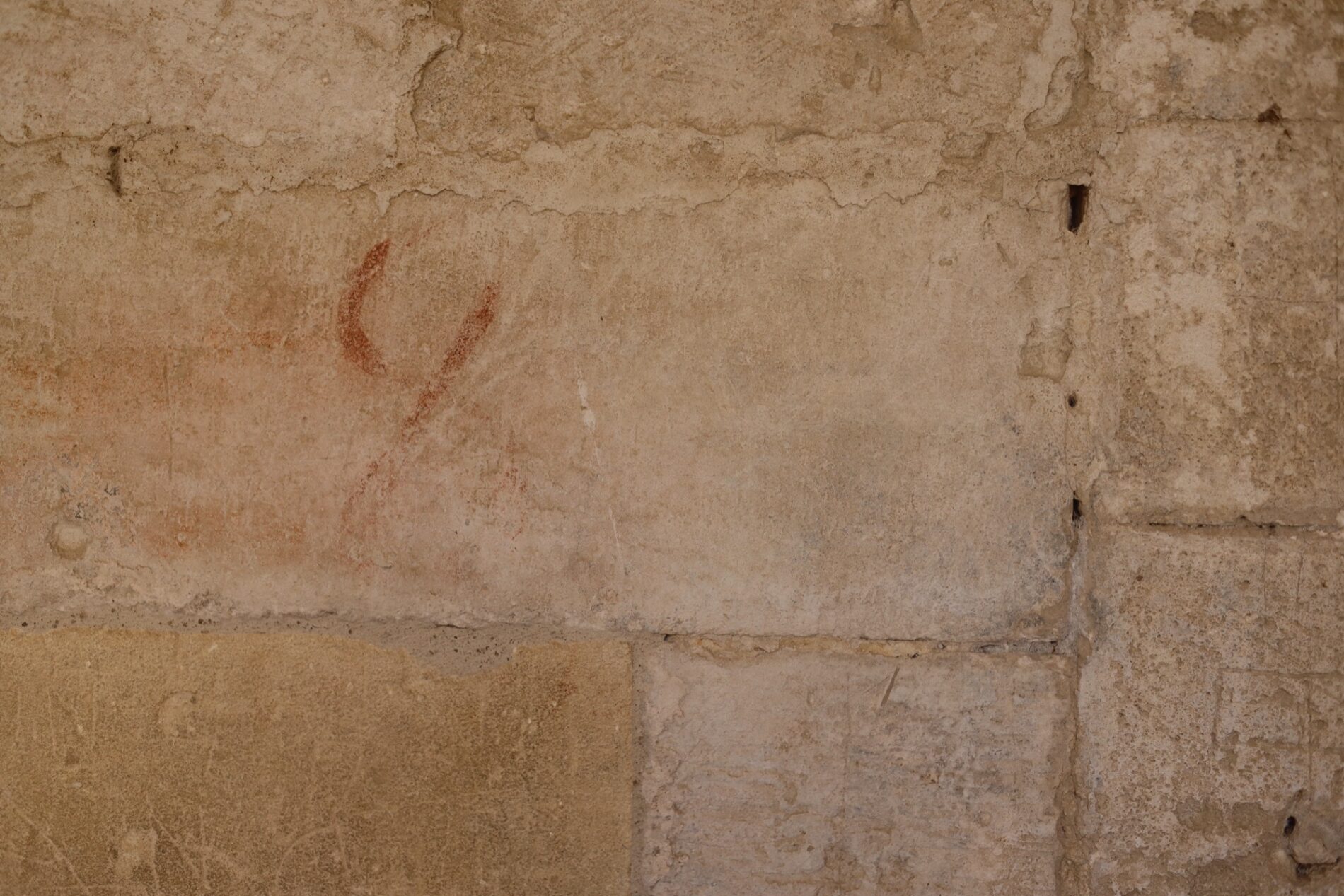Traces of red pigment on the masonry.